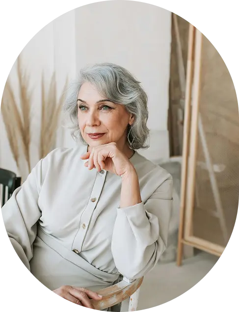 older woman with grey hair gazing out